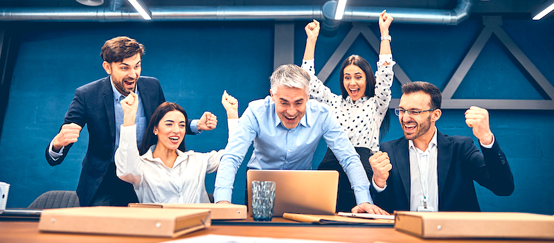 Group of young coworker working together in modern coworking studio and feeling pride of cool idea